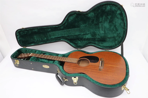 A Martin acoustic guitar with original storage case