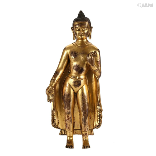 A GILT-BRONZE FIGURE OF STANDING SHAKYAMUNI