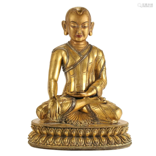 A GILT-BRONZE FIGURE OF A LAMA