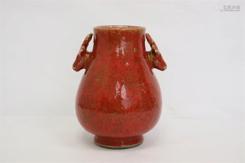 A red glazed porcelain jar with deer motif handles