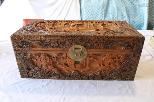 An elaborately carved camphor wood chest