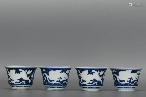 FOUR CHINESE BLUE-AND-WHITE CUPS DEPICTING ' LIONS PURS...