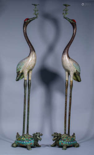 Pair of ancient Chinese enamel colored cranes stepping on to...