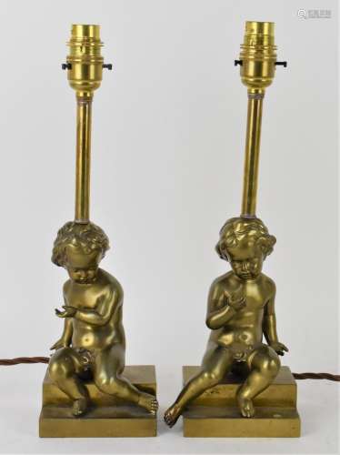 A pair of early 20th century bronze lamps, each modelled as ...