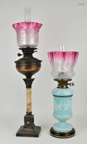 Two early 20th century oil lamps, to include one with blue o...