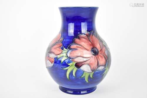A William Moorcroft ceramic baluster vase in the `anemone` p...
