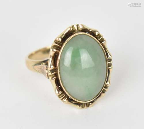 A 9ct yellow gold mounted green jade dress ring, the central...