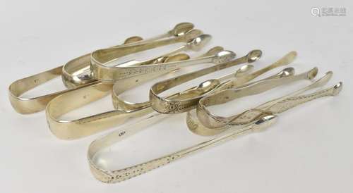 A collection of George III silver sugar tongs, some with sti...