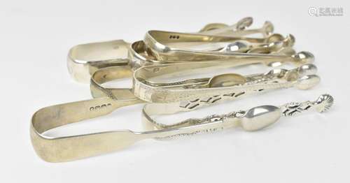 A collection of Georgian and Victorian silver sugar tongs, s...