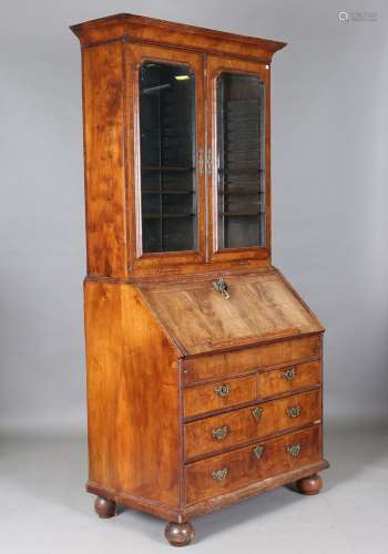 A Queen Anne walnut bureau bookcase with overall feather and...