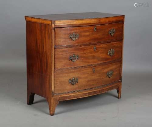 A George III mahogany bowfront chest of three drawers with s...