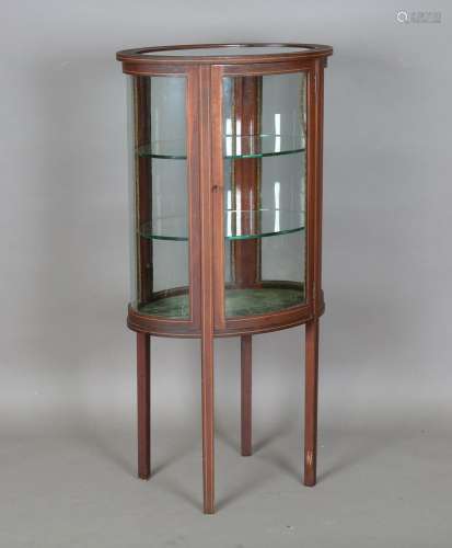 An Edwardian mahogany oval display cabinet with boxwood stri...