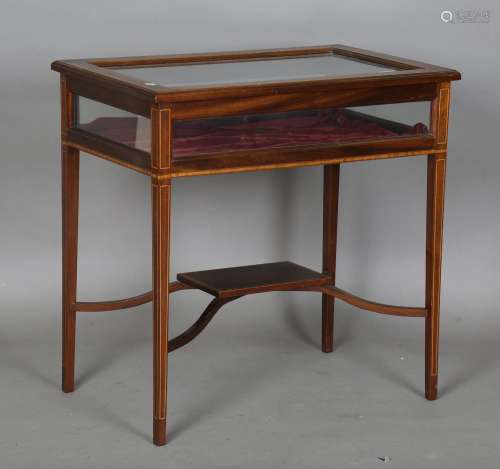 An Edwardian mahogany bijouterie table with bevelled glass t...
