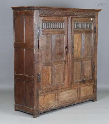 A 17th century and later oak panelled cupboard