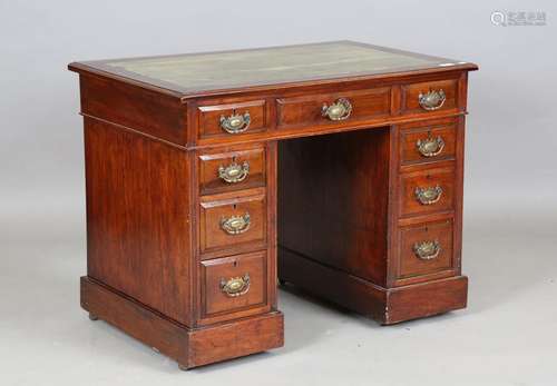 An Edwardian walnut twin pedestal desk of small proportions