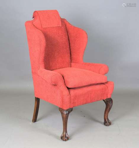 An early 20th century George III style wing back armchair