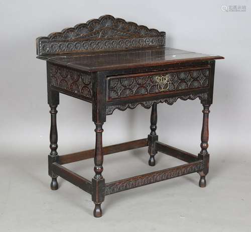 An early 18th century oak side table with later carved decor...