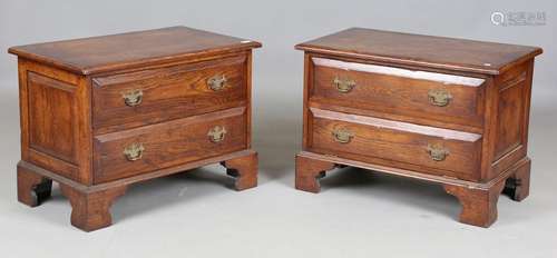 A pair of modern reproduction oak bedside chests of two draw...