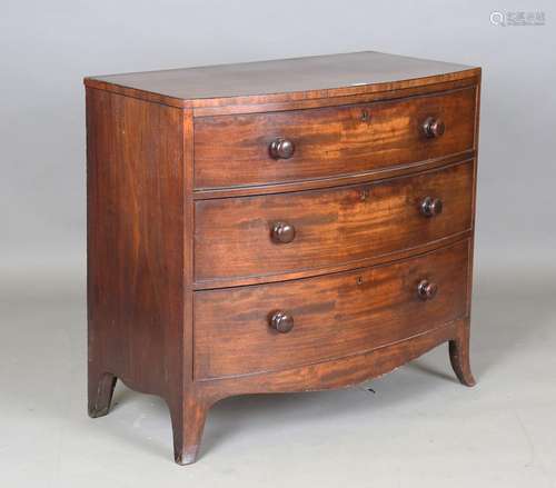 A Regency mahogany bowfront chest of three long drawers with...