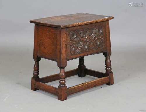 A late 20th century oak and elm box seat stool with carved f...