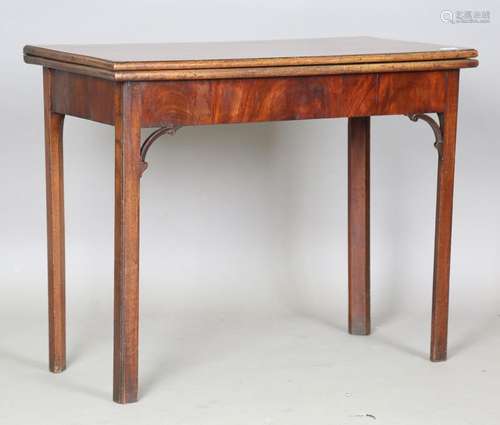 A George III mahogany fold-over concertina-action card table