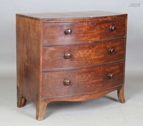 A Regency mahogany bowfront chest of three long drawers with...