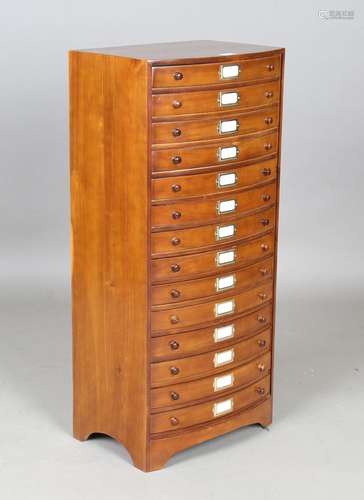 A modern hardwood bowfront chest of fourteen drawers