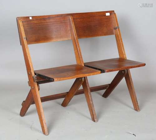 An early 20th century stained ash twin-seated folding bench