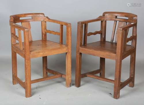 A near pair of Indian Colonial elm tub back chairs