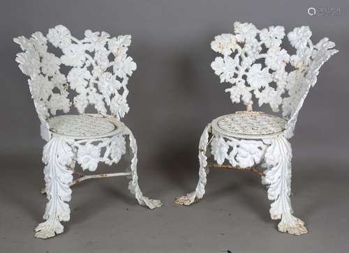 A pair of Victorian cast iron garden chairs