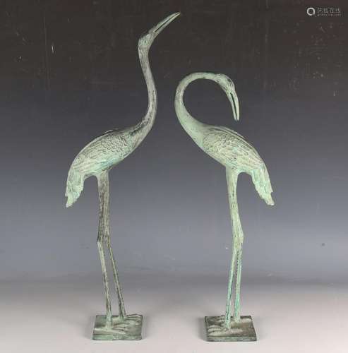 A pair of verdigris cast metal models of storks