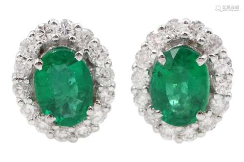 Pair of 18ct white gold oval emerald and round brilliant cut...