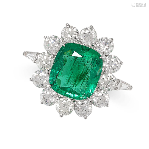 AN EMERALD AND DIAMOND CLUSTER RING set with a cushion cut e...