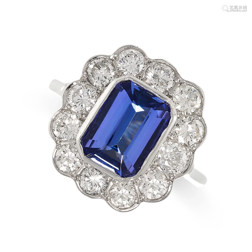 A TANZANITE AND DIAMOND CLUSTER RING in platinum, set with a...