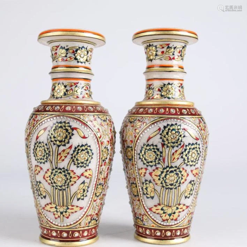 A PAIR OF COLORED WHITE MARBLE DISPLAY BOTTLES.