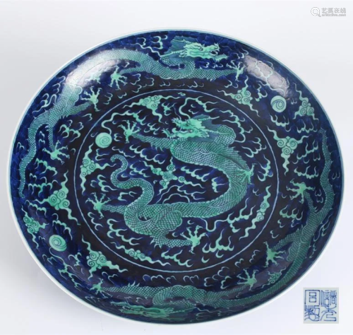 A GREEN GLAZED PORCELAIN PLATE, BLUE BASE.