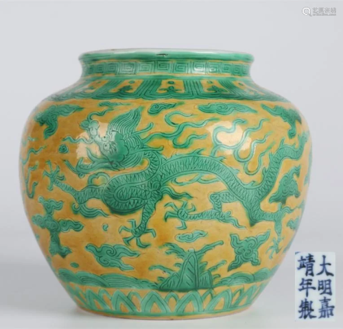 A PORCELAIN JAR WITH GREEN DRAGON DESIGN.