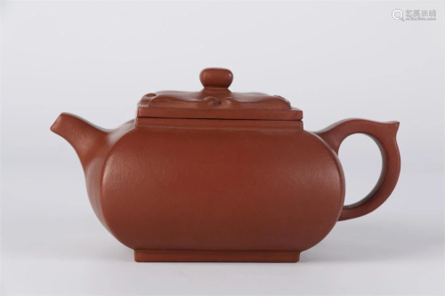 A SQUARE PURPLE CLAY TEAPOT.