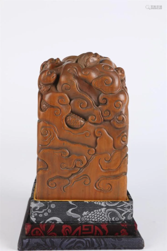 A SANDALWOOD SEAL WITH DRAGON DESIGN.