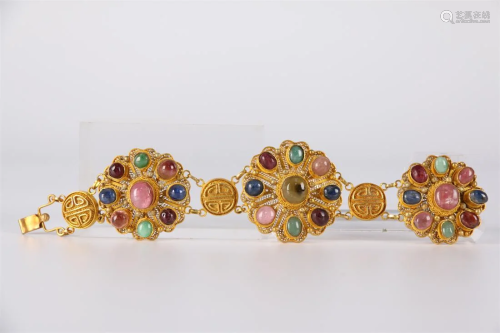 A GILT SILVER BRACELET, INLAID WITH JEWELS.