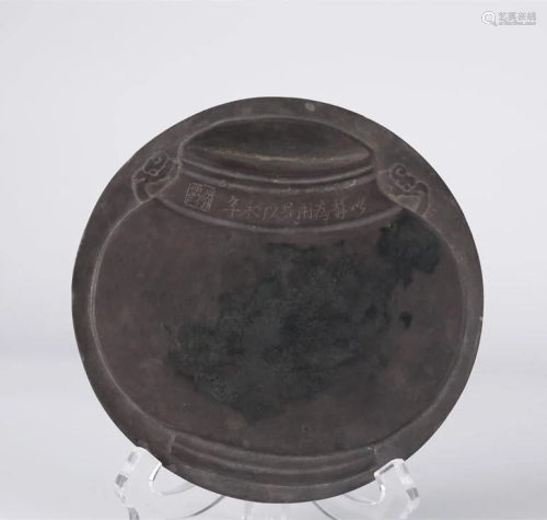 A DUANZHOU INKSTONE WITH CARVED BOTTLE DESIGN.