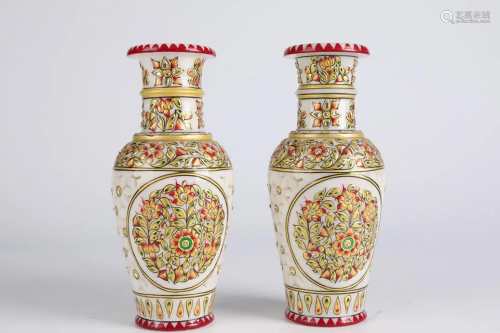 A PAIR OF COLORED WHITE MARBLE DISPLAY BOTTLES.