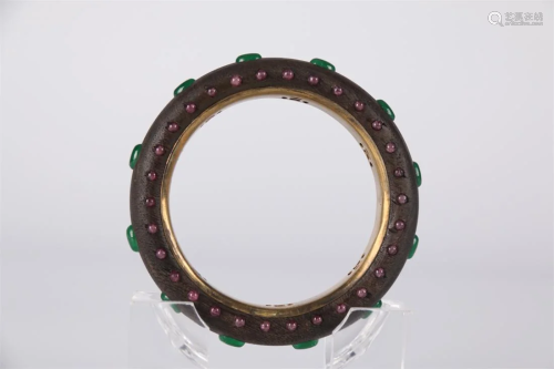 AN AGALWOOD BANGLE, INLAID WITH JEWELS.