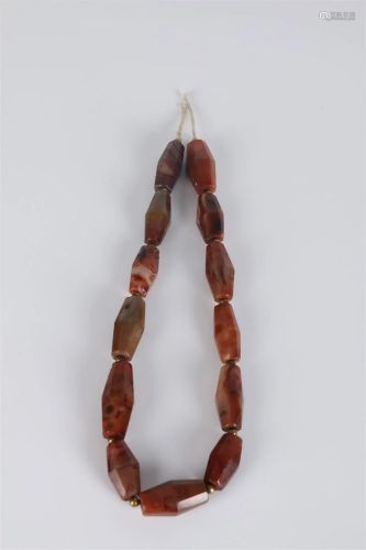A STRING OF AGATE BEADS.