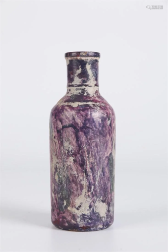 A MALLET-SHAPED GLASS BOTTLE.