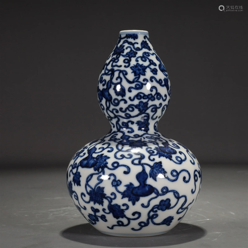 A Blue And White 'Scrolling Gourd' Gourd-Shaped Va...