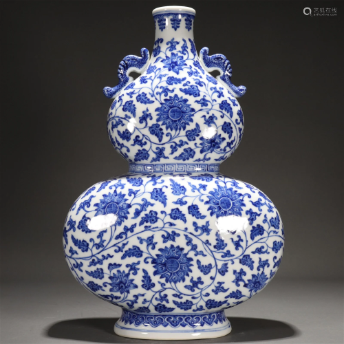 A Blue And White 'Scrolling Flower' Gourd-Form Vas...