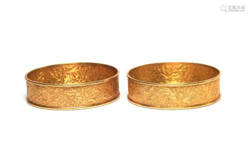 A pair of gilded metal small trays decorated with floral vin...
