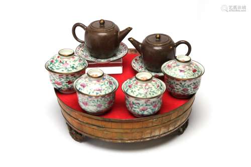 A polychrome porcelain tea set comprising of covered teacups...