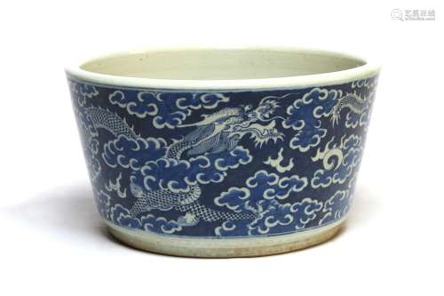 A large blue and white porcelain planter painted with dragon...